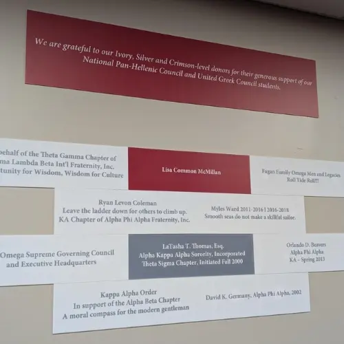 donor wall plaques on display - some are crimson, some are white, some are gray